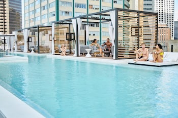 Seasonal outdoor pool, cabanas (surcharge), pool umbrellas at Thompson Dallas, by Hyatt