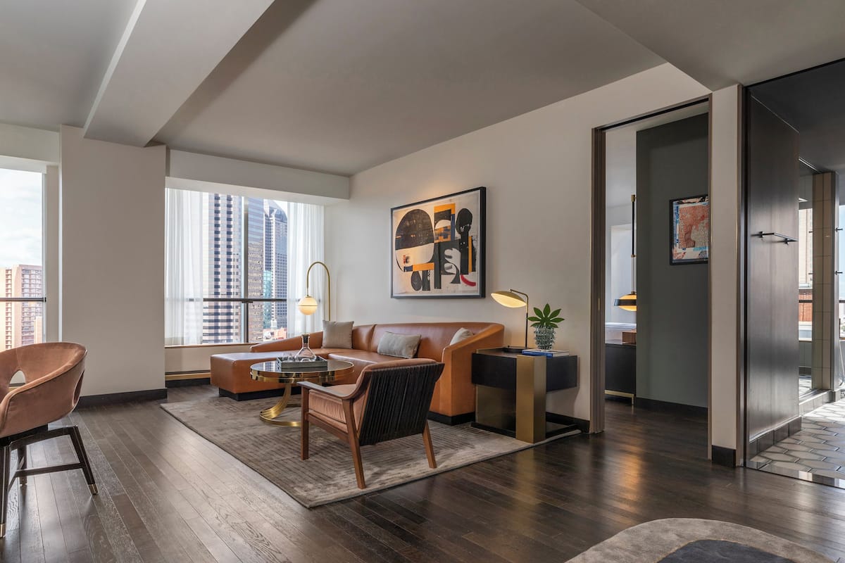 Deluxe Suite, Corner | Living area | 55-inch flat-screen TV with cable channels, TV, Netflix