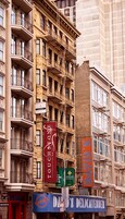 A multi-story building with a red banner advertising the Hotel St. Louis.