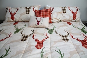 A bed with a patterned bedspread featuring deer and antlers. - Sugar Ski & Country Club Unit 414 Silver (Banner Elk)
