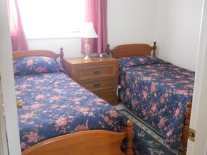 A bedroom with two beds, a nightstand, and a lamp. - Sugar Ski & Country Club Unit 422 Bronze (Banner Elk)