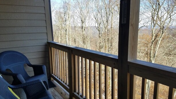 A wooden deck with a view of leafless trees and mountains. - Sugar Ski & Country Club Unit 224 Gold (Banner Elk)