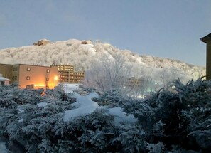 A snow-covered hill with buildings in the background. - 10-503 (Banner Elk)