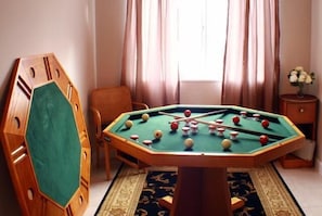 Relax in this inviting space with a pool table and comfortable seating areas.
