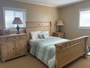 A bedroom with a wooden bed, a nightstand, a dresser, and a window with blinds. - Sugar Ski & Country Club Unit 336 Bronze (Banner Elk)