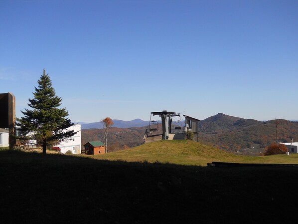 A ski lift chair with a mountain view in the background. - Sugar Ski & Country Club Unit 511 Gold (Banner Elk)
