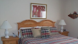 A neatly made bed with plaid bedding, two bedside lamps, and a framed picture on the wall. - Sugar Ski & Country Club Unit 822 Silver (Banner Elk)