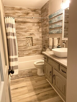 Combined shower/tub, hair dryer, towels, toilet paper