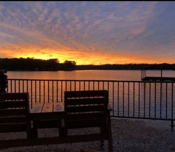 Sit on the bench and enjoy the tranquil view of the lake.