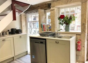 Enjoy cooking in this well-equipped kitchen with a dishwasher and stainless steel sink.