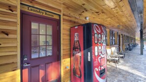 A wooden building with a red door labeled "Laundry Room" and a Coca-Cola vending machine. - 14 on the Ridge, Pet Friendly! (Pigeon Forge)