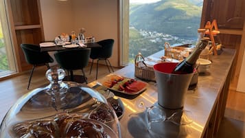 A breakfast buffet with a variety of pastries, fruits, and a bottle of champagne.