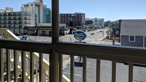 A motel sign with a clear view of the surrounding buildings, including a Starbucks and a hotel. - Crystal Sands Motel (Ocean City)