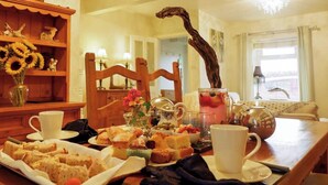 A breakfast table with various pastries, a teapot, and cups. - 2 bedroom accommodation in Swarthmoor, near Ulverston (Swarthmoor, near Ulverston)