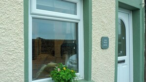 A house with a window displaying a plant and a sign reading "144 Wild Duck". - 2 bedroom accommodation in Swarthmoor, near Ulverston (Swarthmoor, near Ulverston)