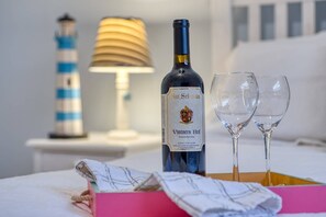 A bottle of San Sebastian Vintners Red wine, two empty wine glasses, a lighthouse model, a lamp, and a pink box with a towel. - St Augustine South (St. Augustine)