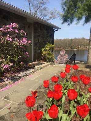 A stone building with a stone pathway leading to a dock over water.