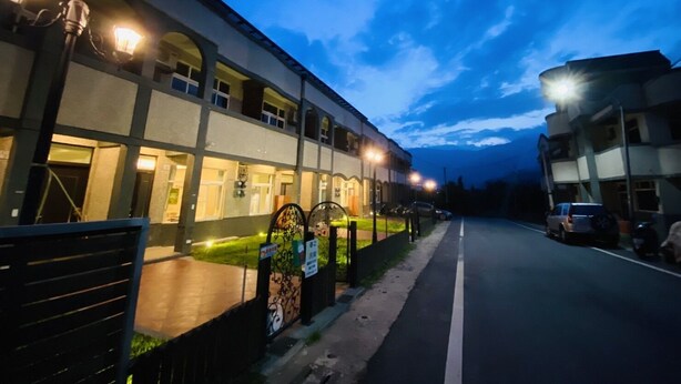 A building with multiple windows and a gated entrance, suggesting it might be a hotel or residential complex. - Spring Hall (Luye)