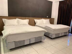 Two beds with white bedding in a room with a wooden headboard and a dark wall. - Spring Hall (Luye)