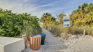 A pathway with trash bins and a signboard. - Beachfront Siesta Key Condo w/ Enclosed Patio (Siesta Key)
