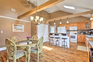 Enjoy meals in the traditional kitchen and dining area with a round table and comfortable seating.