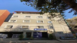 A hotel named 'Hotel Shyam Inn' with a signboard displaying the name and contact number. - Hotel Shyam Inn (Bengaluru)