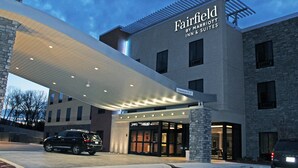 A Marriott Fairfield hotel with a covered entrance, stone facade, and a clear sky.