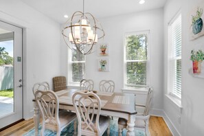 Enjoy meals in this elegant dining area with a large chandelier and six comfortable chairs.