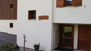 A building with wooden shutters, a small window, and a sign reading "Bel Alp". - Cozy Apartment for 4-6 in Village Center with Terrace and Parking (BLA003) (Saint-Jean-de-Sixt)
