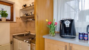 A kitchen with a coffee maker, a sink, a cabinet, and a window with a view. - Holiday Apartment "Munding" with Garden, Terrace, Lake View, Grill & SAT-TV (Überlingen)