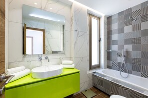 Bathtub, rainfall showerhead, hair dryer, towels