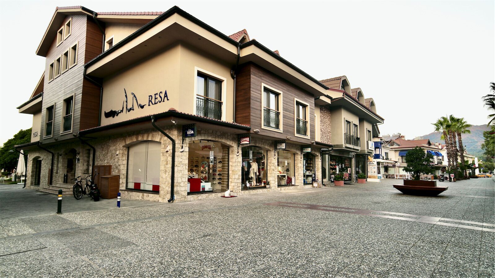 A multi-story building with a storefront labeled "RESA" on the ground floor.