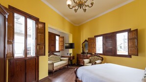 A bedroom with a large bed, wooden wardrobe, a desk, and a chair. - HomeForGuest NEW Duplex with Rooftop next to Arucas Cathedral (Arucas)