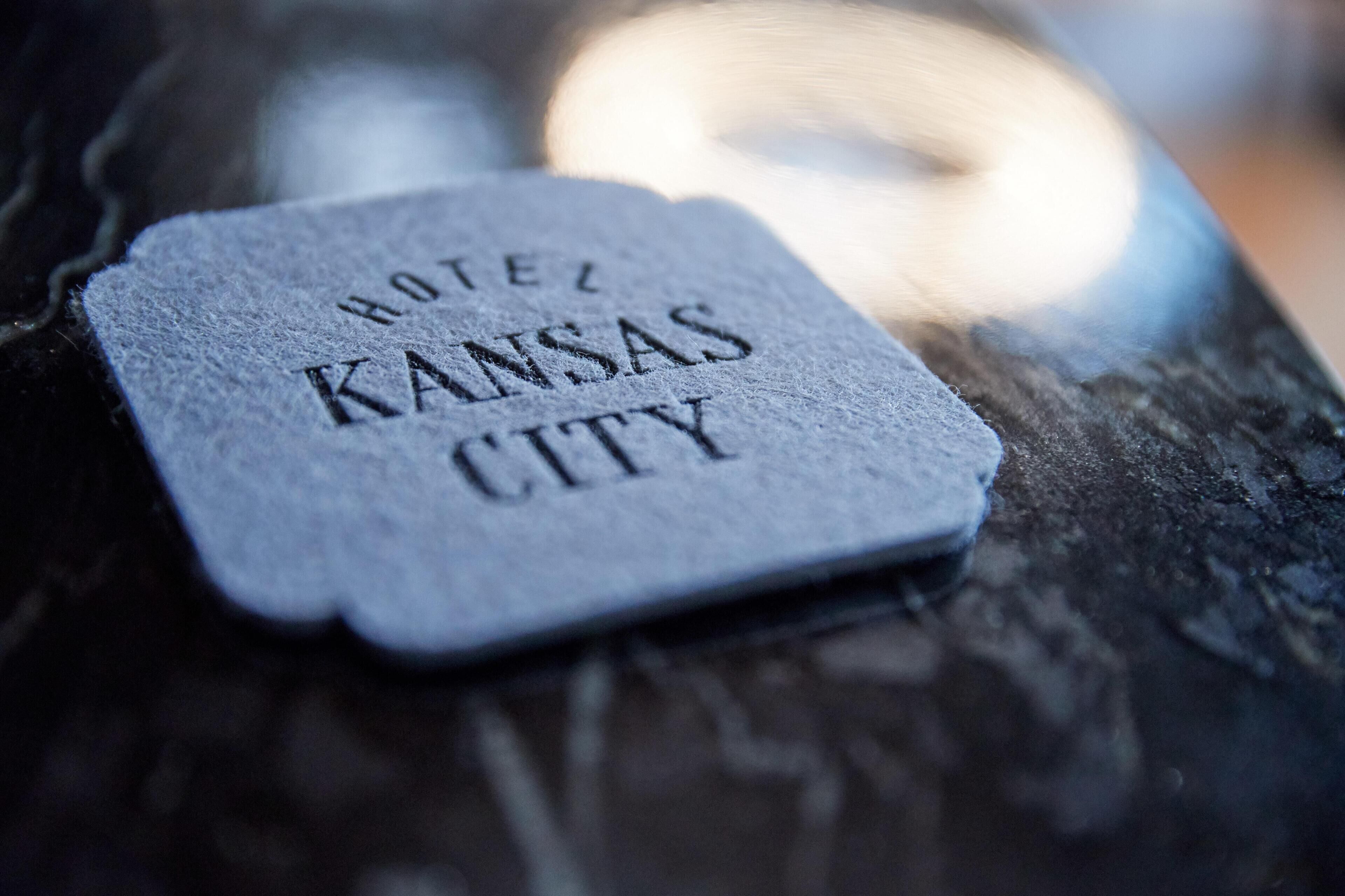 A hotel sign with the name 'HOTEL KANSAS CITY' engraved on it.