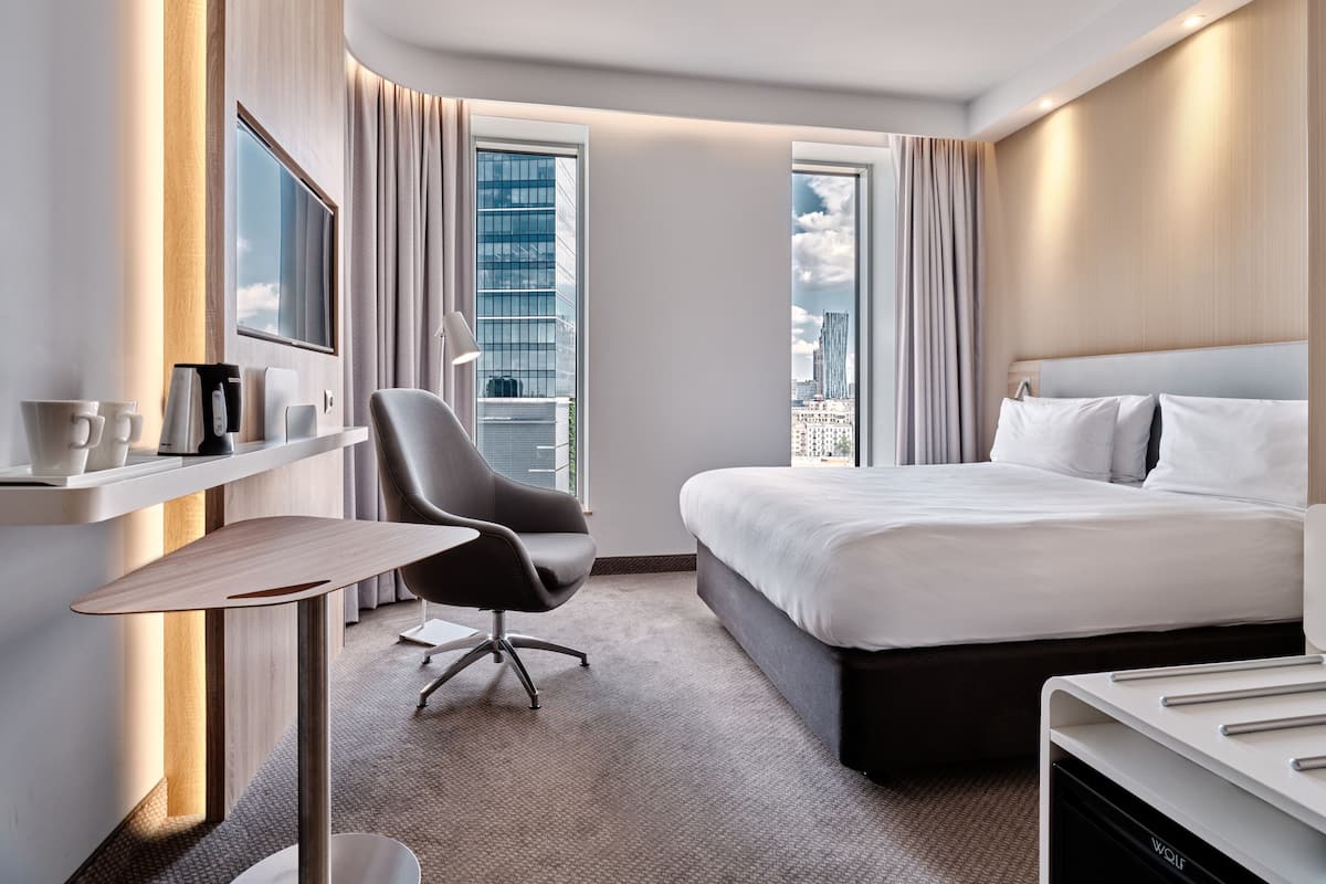 Hypo-allergenic bedding, desk, laptop workspace, blackout drapes
