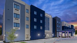 A multi-story hotel with a modern design, featuring a prominent 'Staybridge Suites' sign. - Staybridge Suites Waco South - Woodway by IHG (Waco)