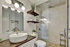 Sink, shower, and toiletries are conveniently located in this bathroom.