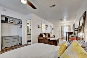 Relax in this serene space with a large bed, comfortable sofa, and convenient dresser.