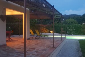 A covered outdoor area with stone flooring, a table with chairs, and a pergola with a star decoration. - Detached cottage for 2 Villa Garlaban Gemenos **** (GEMENOS)