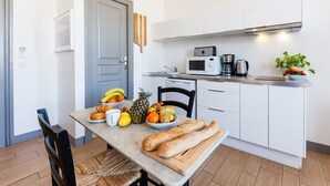 A compact kitchen with white cabinets, a microwave, a coffee maker, and a small countertop with a plant. - AZUR - LES COCONS - Studio Apartment, Sleeps 2 (Marseille)