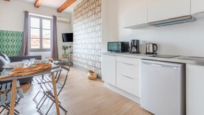 A modern kitchen with white cabinets, a built-in oven, and a coffee maker. - JADE - LES COCONS - One Bedroom Apartment, Sleeps 2 (Marseille)