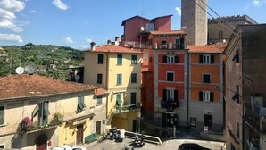 A historic town with colorful buildings, a prominent tower, and a clear blue sky. - The house in the carob trees with breathtaking views (Arcola)