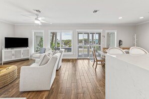 Relax in this spacious living room with a flat-screen TV, comfortable sofas, and a dining area.