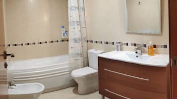 Bathtub, hair dryer, bidet, towels