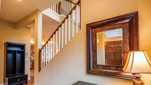 A staircase with wooden railings and a dark wooden cabinet with drawers. - Kidd Island (CDA) Lakefront Beauty-Amazing views! (Coeur d'Alene)