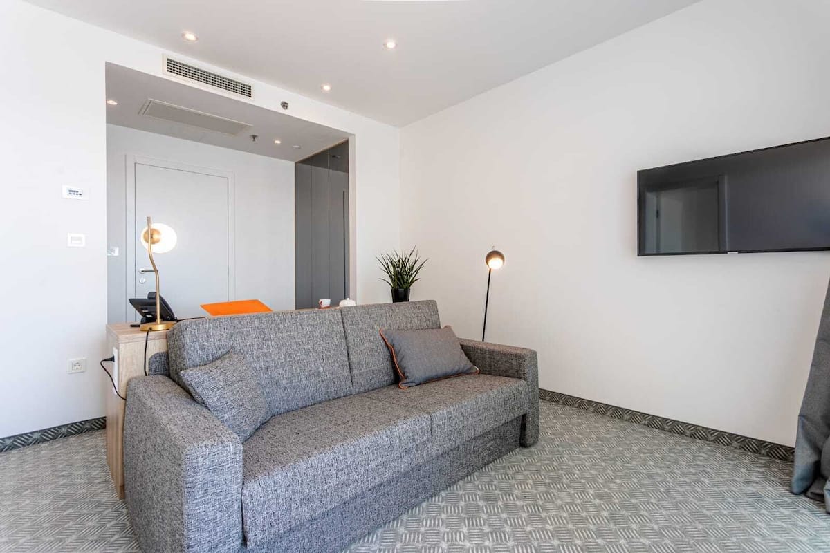 deluxe suite, balcony, sea view | living area | 80-cm lcd tv with satellite channels, tv