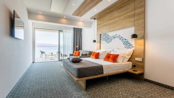 A modern hotel room with a large bed, a view to the outside, and a wooden accent wall.