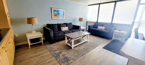 A living room with two sofas, a coffee table, and a small side table with lamps. - Steps from the beach! 3bed/2bath Mid-town condo! (Ocean City)