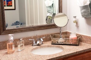 A bathroom with a granite countertop, a sink, a mirror, and a towel rack. - Beautiful Inter-Coastal Waterway Sunset Getaway!!! (Palm Coast)