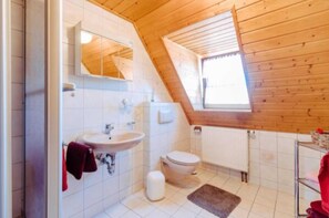 Shower, hair dryer, towels, toilet paper